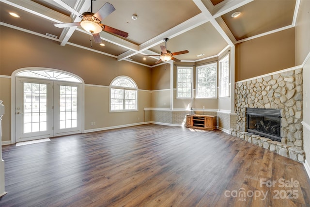 unfurnished living room with a ceiling fan, coffered ceiling, a fireplace, dark wood-style flooring, and beam ceiling