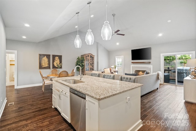 kitchen with dishwasher, lofted ceiling, plenty of natural light, and a sink