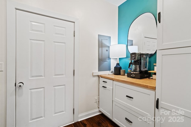 interior space featuring wood finished floors, vanity, and baseboards
