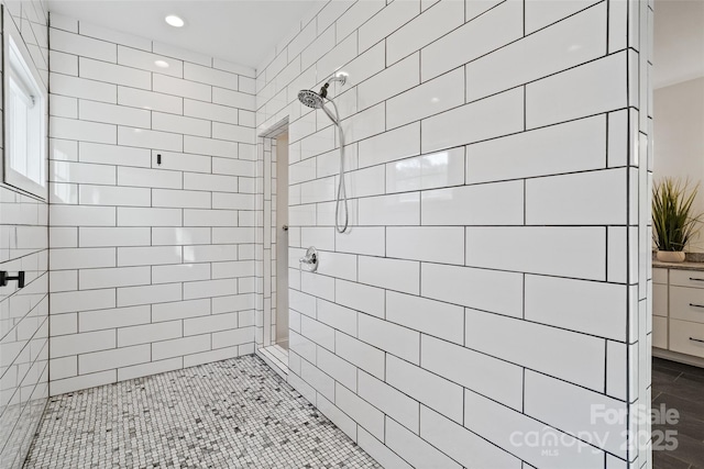 full bath with recessed lighting and tiled shower