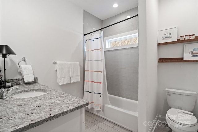 bathroom with wood finished floors, vanity, shower / bathtub combination with curtain, and toilet