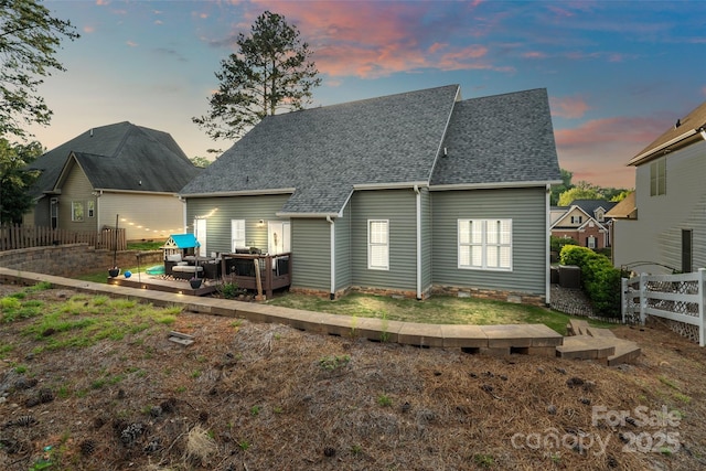 rear view of property featuring central AC unit, a chimney, fence, a wooden deck, and a shingled roof