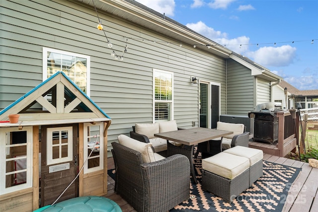 wooden terrace with grilling area and outdoor dining area