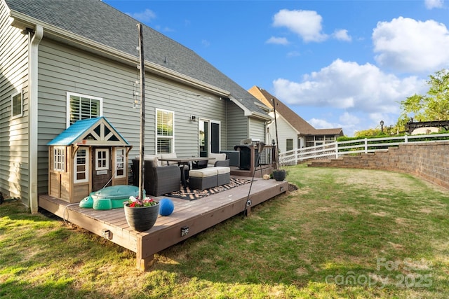 back of property with an outdoor living space, a deck, a shingled roof, a fenced backyard, and a yard