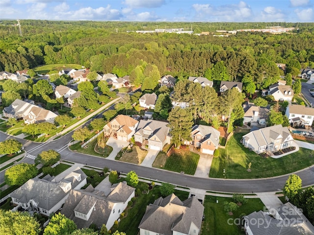 birds eye view of property featuring a residential view and a view of trees
