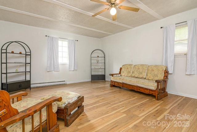 living area featuring a baseboard radiator, light wood-style floors, a ceiling fan, and a textured ceiling
