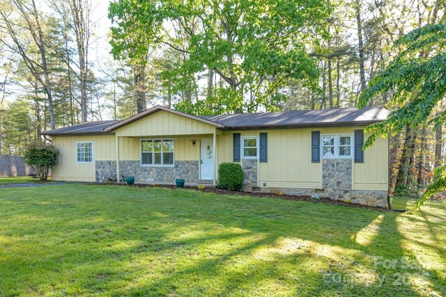 ranch-style house with a front yard and stone siding