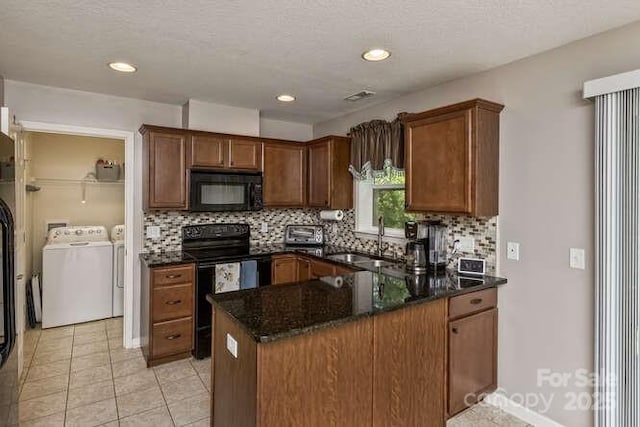 43 Sunny Meadows Blvd, Arden, NC 28704 - kitchen with black appliances, separate washer and dryer, a sink, decorative backsplash, and a peninsula