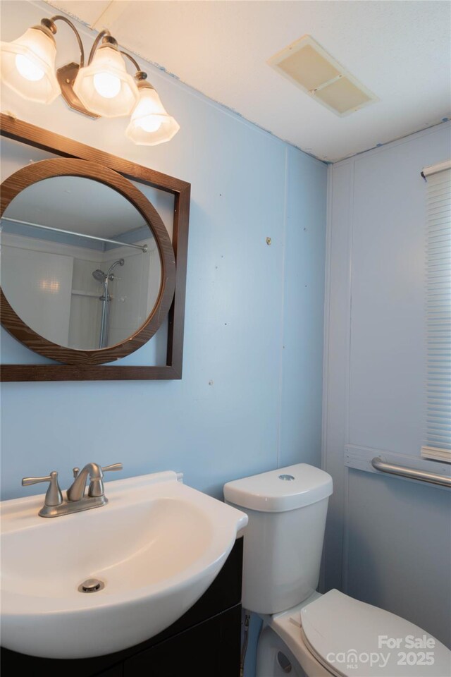 bathroom with toilet and vanity