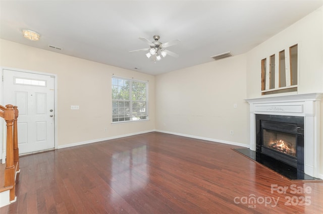 827 Gentlewinds Ct, Fort Mill, SC 29708 - unfurnished living room with a glass covered fireplace, a ceiling fan, baseboards, wood finished floors, and visible vents