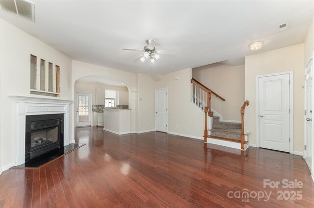 827 Gentlewinds Ct, Fort Mill, SC 29708 - unfurnished living room with ceiling fan, a fireplace with raised hearth, wood finished floors, and visible vents