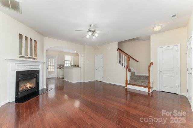 827 Gentlewinds Ct, Fort Mill, SC 29708 - unfurnished living room featuring visible vents, a ceiling fan, a glass covered fireplace, and wood finished floors