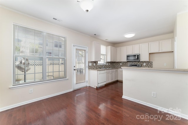 827 Gentlewinds Ct, Fort Mill, SC 29708 - kitchen featuring white cabinets, dishwasher, stainless steel microwave, tasteful backsplash, and dark wood-type flooring