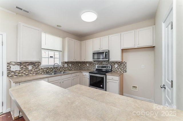 827 Gentlewinds Ct, Fort Mill, SC 29708 - kitchen with light countertops, appliances with stainless steel finishes, decorative backsplash, and a sink