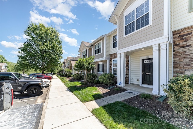 827 Gentlewinds Ct, Fort Mill, SC 29708 - view of side of home featuring a residential view, uncovered parking, and stone siding