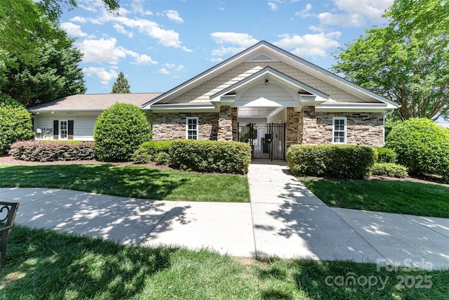 827 Gentlewinds Ct, Fort Mill, SC 29708 - view of front facade featuring fence, a gate, a front lawn, and stone siding