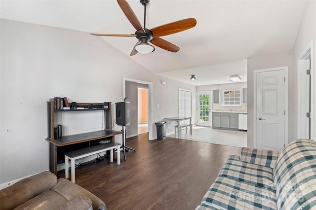 living area with ceiling fan, vaulted ceiling, and wood finished floors