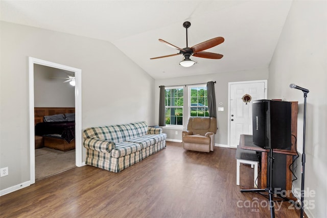 living room with vaulted ceiling, wood finished floors, baseboards, and ceiling fan