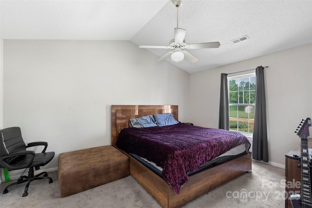 carpeted bedroom featuring lofted ceiling, baseboards, visible vents, and ceiling fan