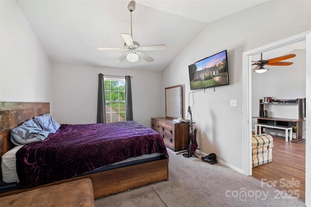 carpeted bedroom with vaulted ceiling, a ceiling fan, and baseboards