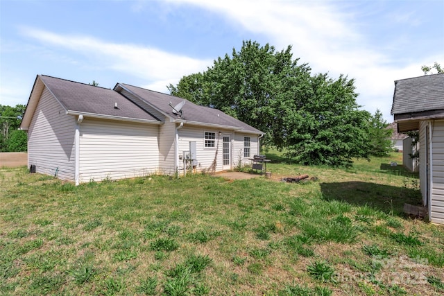 rear view of house featuring a patio area and a lawn