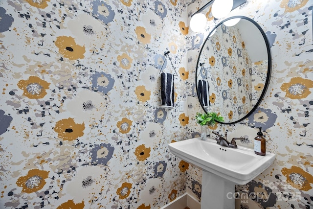 bathroom with baseboards and wallpapered walls
