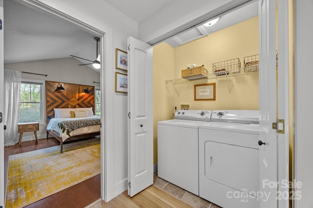 washroom featuring separate washer and dryer, laundry area, a ceiling fan, and light wood finished floors