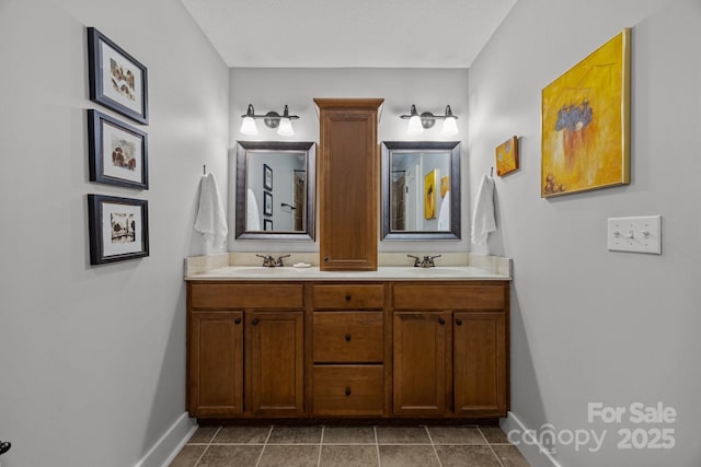 bathroom featuring baseboards, a sink, and double vanity