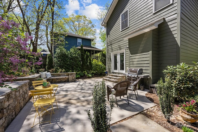 view of patio / terrace with grilling area, french doors, and entry steps