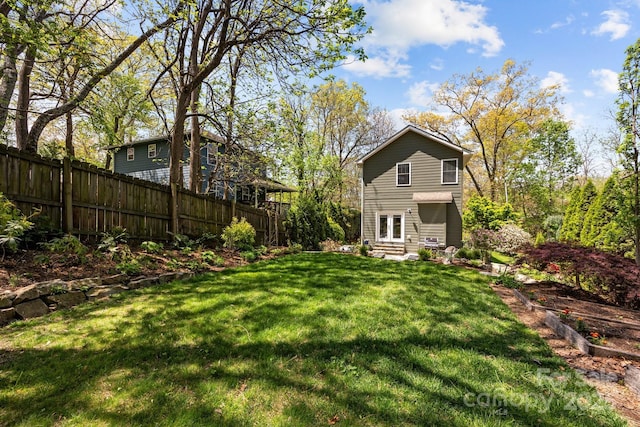 view of yard featuring fence and entry steps