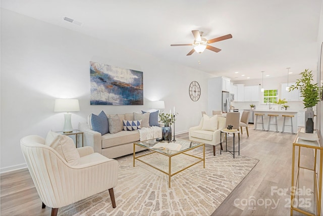 601 Westway Dr, Gastonia, NC 28054 - living room with baseboards, ceiling fan, light wood finished floors, and visible vents