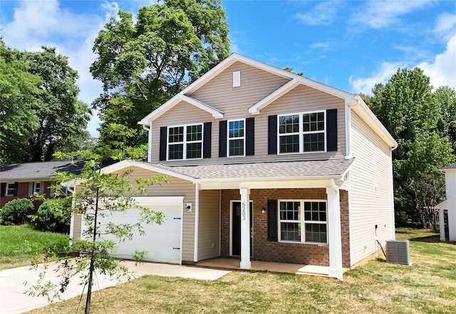 601 Westway Dr, Gastonia, NC 28054 - traditional-style house featuring a porch, concrete driveway, a front yard, central AC, and brick siding