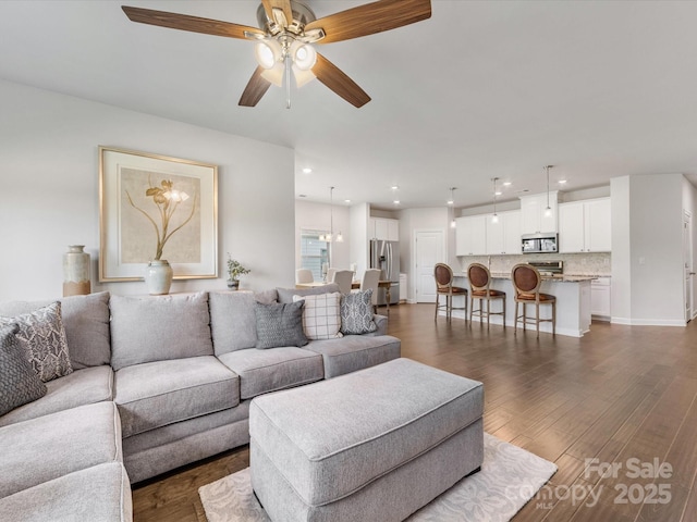 living room featuring recessed lighting, dark wood finished floors, and a ceiling fan