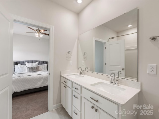 ensuite bathroom featuring double vanity, ensuite bathroom, ceiling fan, and a sink