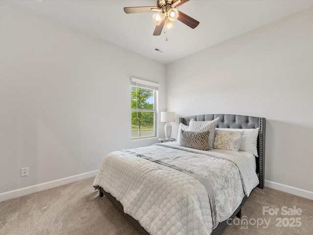 carpeted bedroom featuring ceiling fan, baseboards, and visible vents