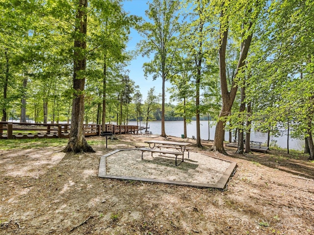 view of community with fence and a water view
