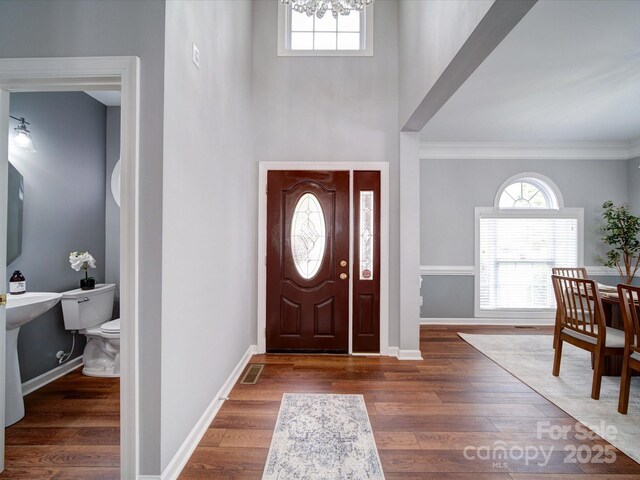 7642 Horseshoe Creek Dr, Huntersville, NC 28078 - entryway with wood finished floors, ornamental molding, a high ceiling, baseboards, and a notable chandelier