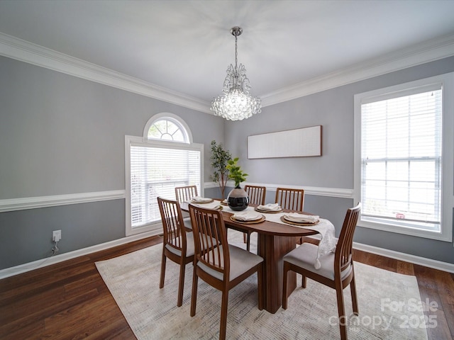 7642 Horseshoe Creek Dr, Huntersville, NC 28078 - dining space featuring wood finished floors, crown molding, baseboards, and an inviting chandelier