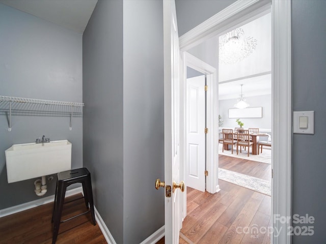 7642 Horseshoe Creek Dr, Huntersville, NC 28078 - interior space featuring baseboards, a notable chandelier, wood finished floors, and a sink