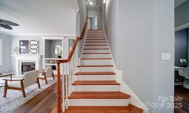 7642 Horseshoe Creek Dr, Huntersville, NC 28078 - staircase featuring wood finished floors and a fireplace