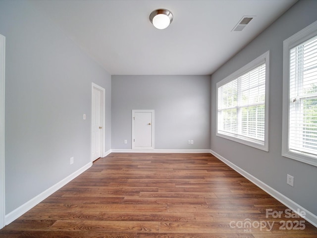 7642 Horseshoe Creek Dr, Huntersville, NC 28078 - unfurnished room featuring baseboards, wood finished floors, visible vents, and a wealth of natural light