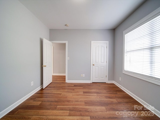 7642 Horseshoe Creek Dr, Huntersville, NC 28078 - unfurnished bedroom with baseboards and wood finished floors
