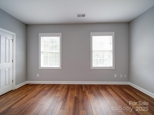 7642 Horseshoe Creek Dr, Huntersville, NC 28078 - spare room featuring plenty of natural light, baseboards, and dark wood-style flooring