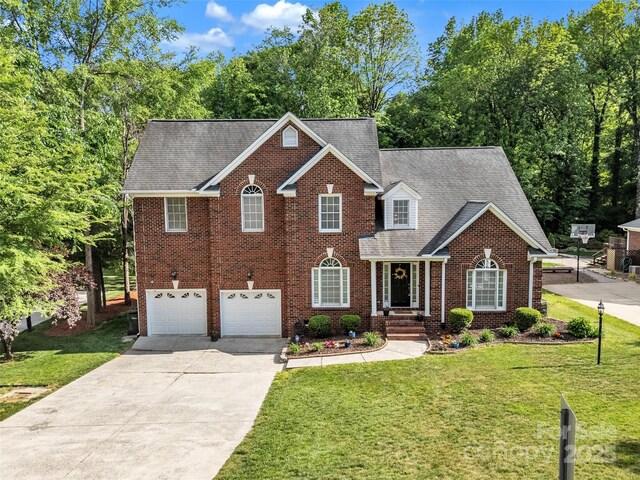 5775 Monticello Dr NW, Concord, NC 28027 - view of front of home with brick siding, a garage, a front yard, and concrete driveway