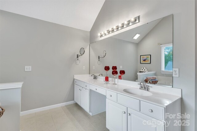 5775 Monticello Dr NW, Concord, NC 28027 - full bath featuring double vanity, high vaulted ceiling, a sink, and tile patterned flooring