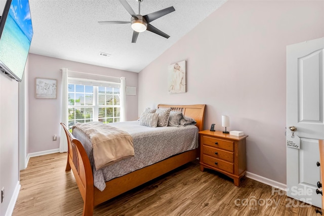 8814 Gerren Ct, Charlotte, NC 28217 - bedroom with visible vents, wood finished floors, baseboards, a textured ceiling, and vaulted ceiling