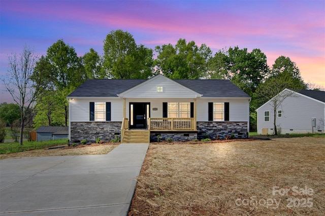 view of front of property featuring covered porch and stone siding
