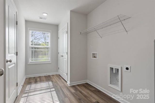 laundry room featuring visible vents, laundry area, wood finished floors, electric dryer hookup, and washer hookup