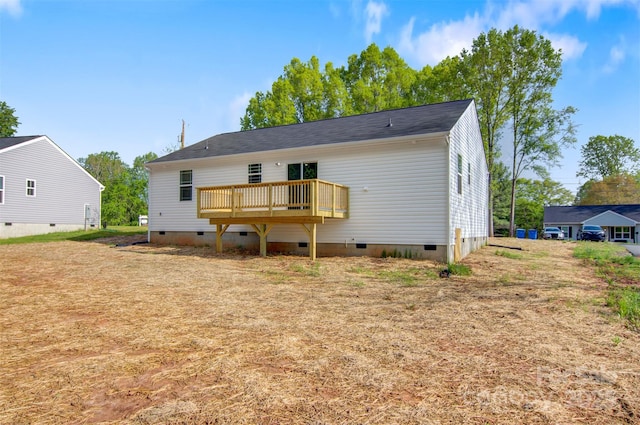 back of property with crawl space and a deck