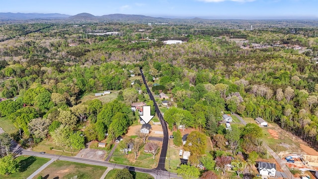 birds eye view of property featuring a mountain view and a forest view